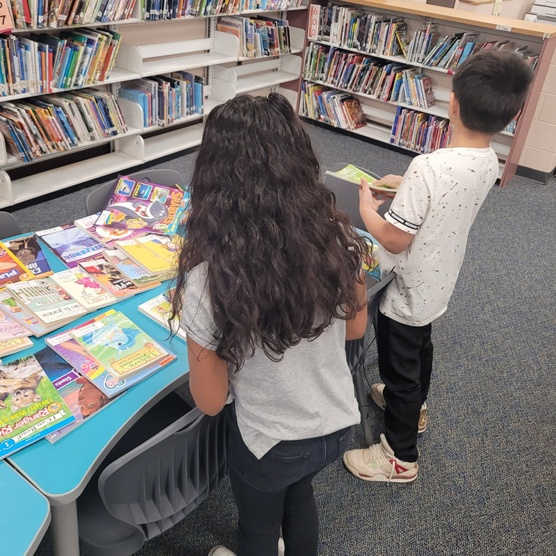 two children look at books