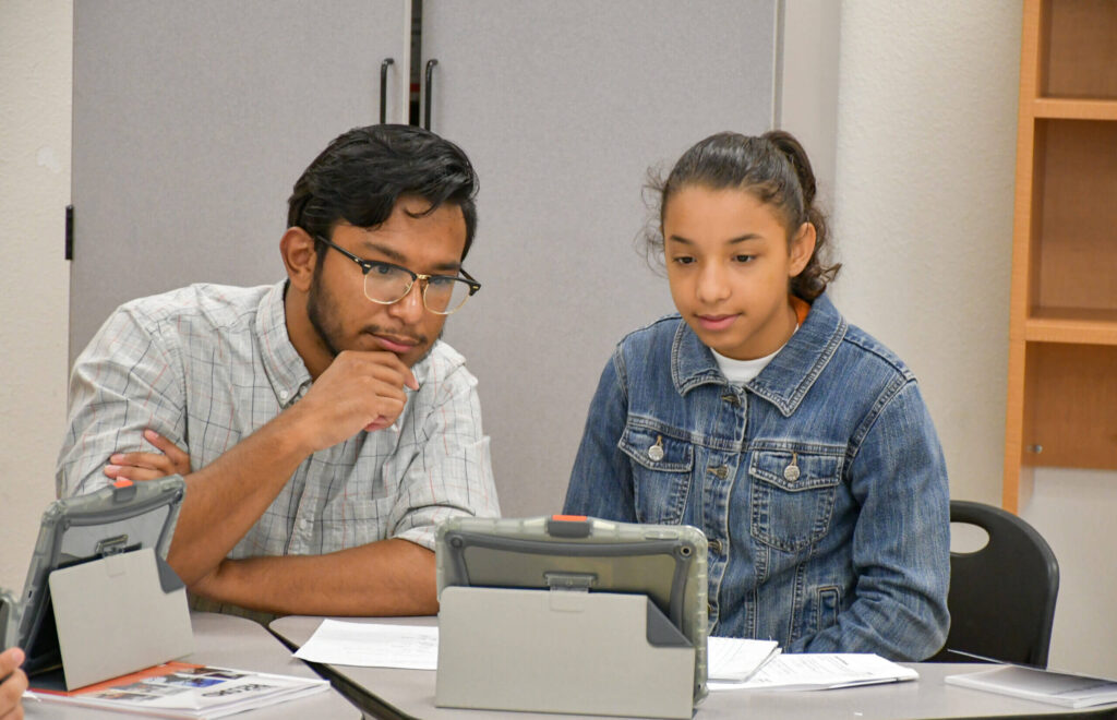 two people working together at a table