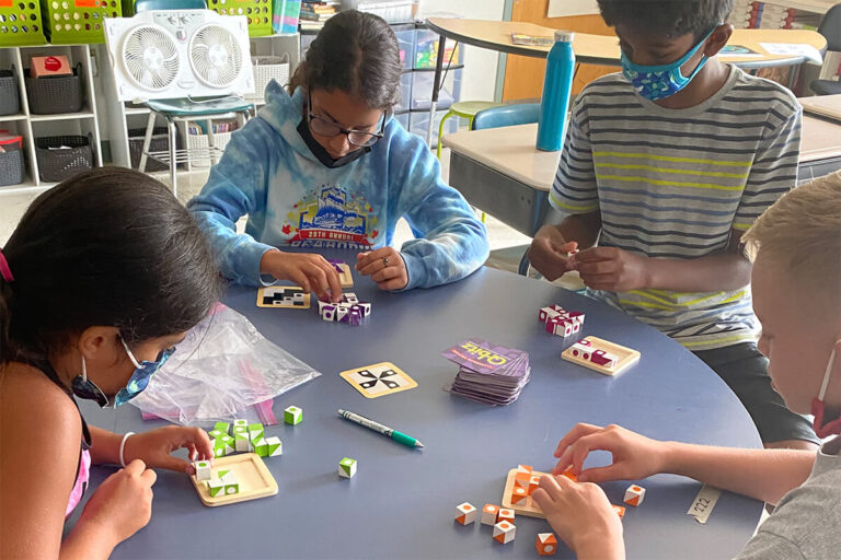 Four students working at a table