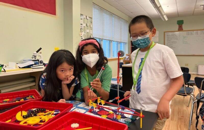 three students in classroom