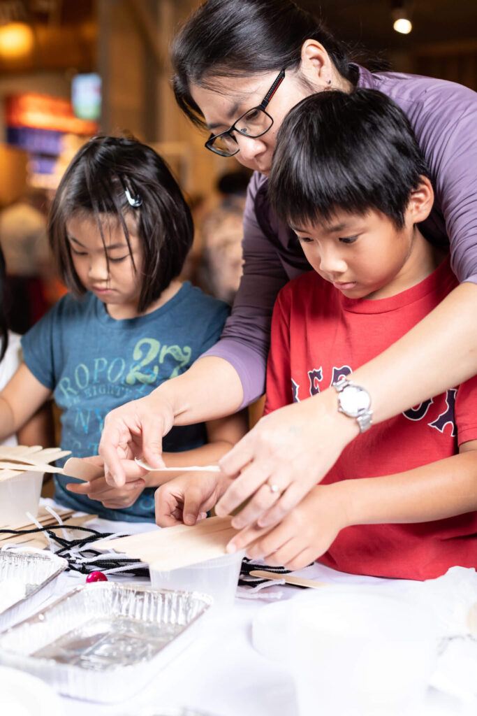 mother helps children with crafts