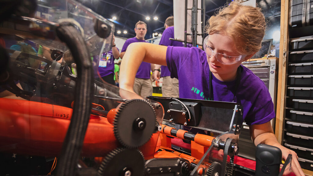 girl works on robot project