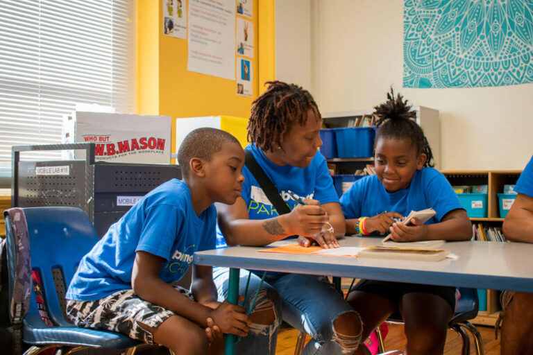 parent sits with children