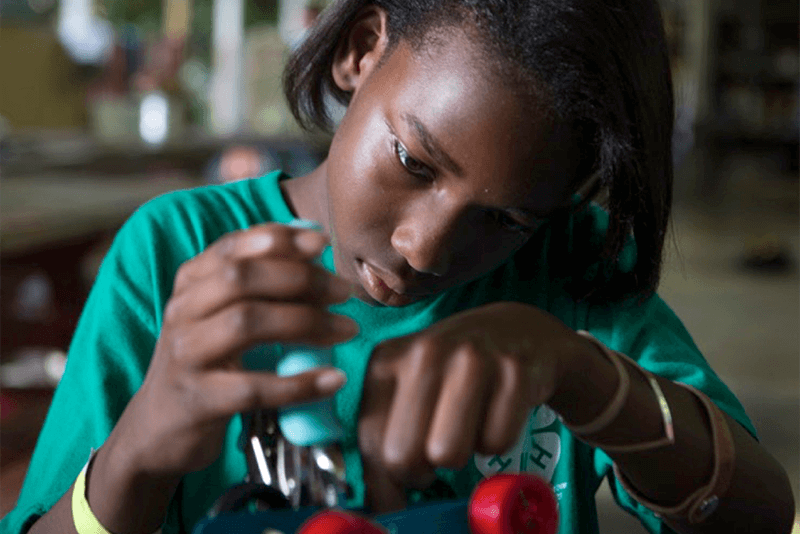 A young girl works on a project