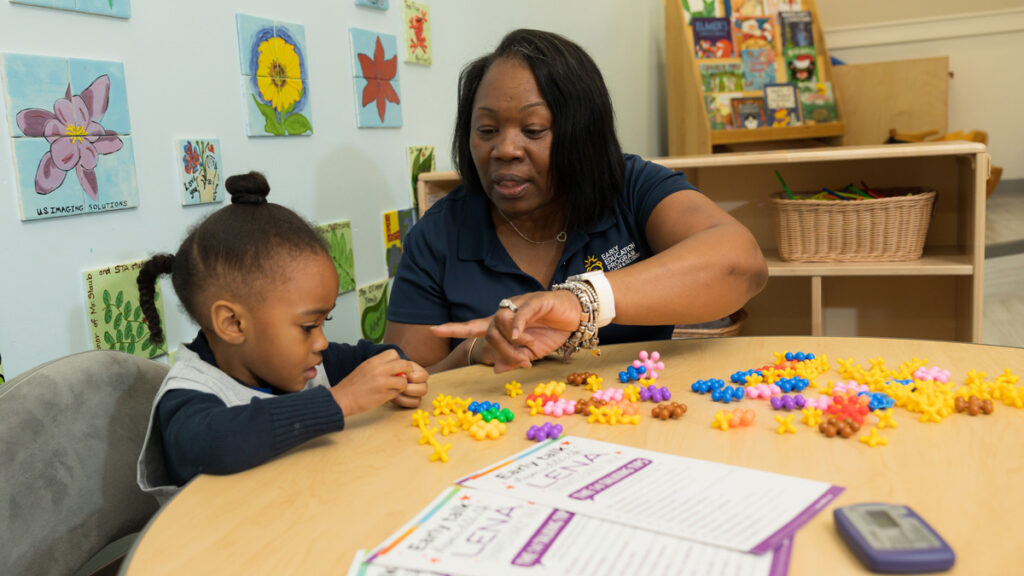LENA educator sits with child