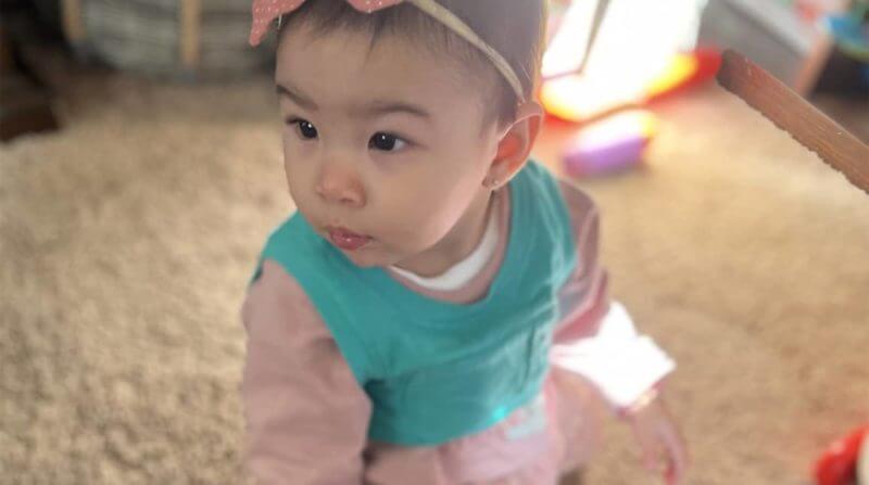 Baby in pink and teal shirt