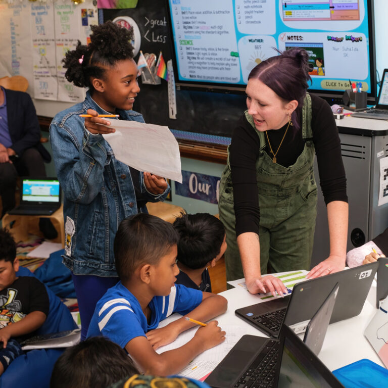 Teacher talks to students in classroom
