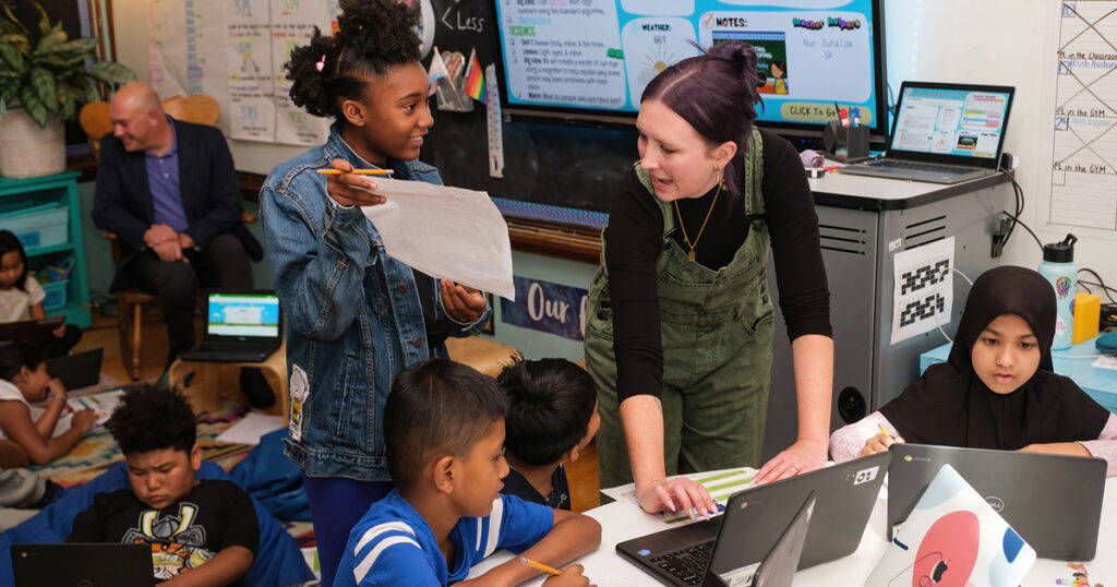 Teacher talks to students in classroom