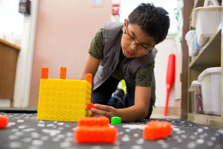 child plays with blocks on the floor