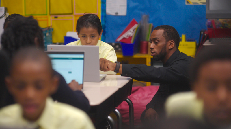 teacher helps student