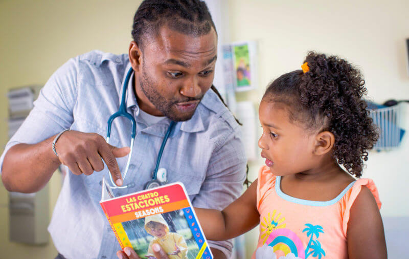 Child and doctor read book