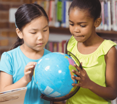 two young girls hold a globe