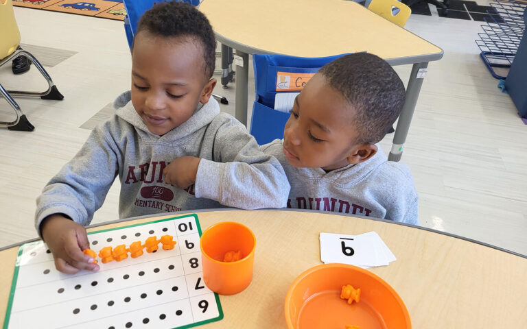 two children sit at table