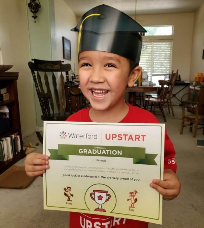 child holds certificate