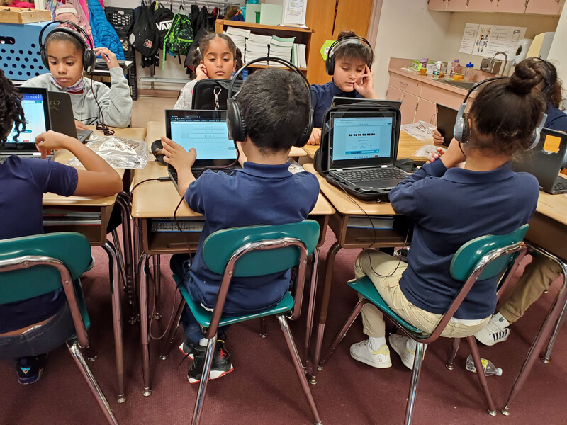 Young students work on laptop computers