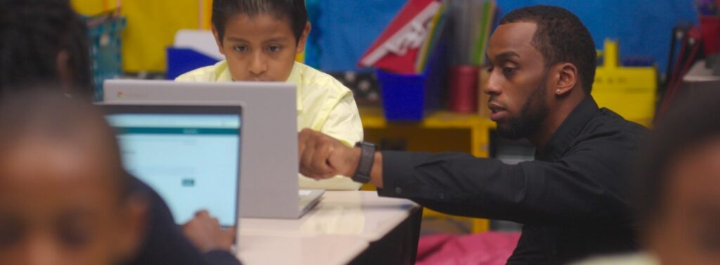 teacher points to screen