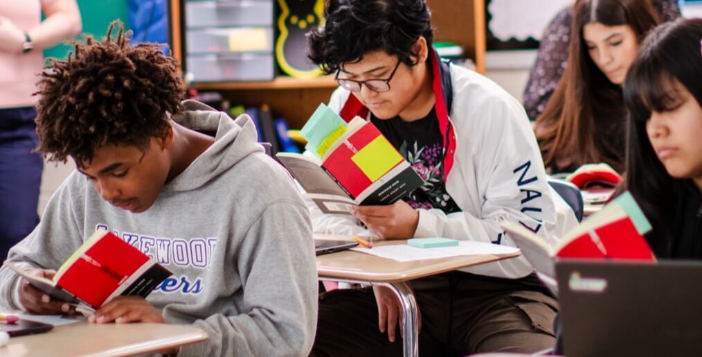 students read book in classroom
