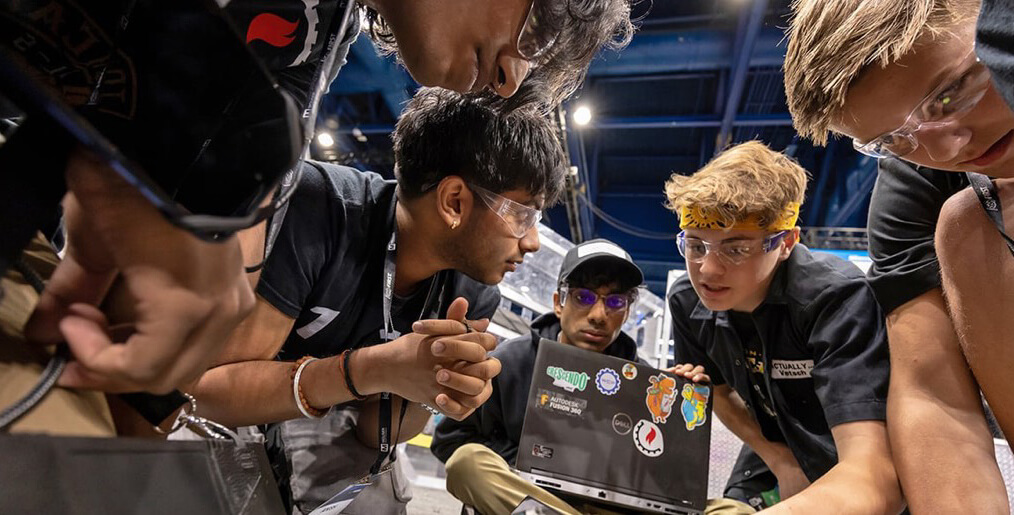 students in a circle at a FIRST robotics competition
