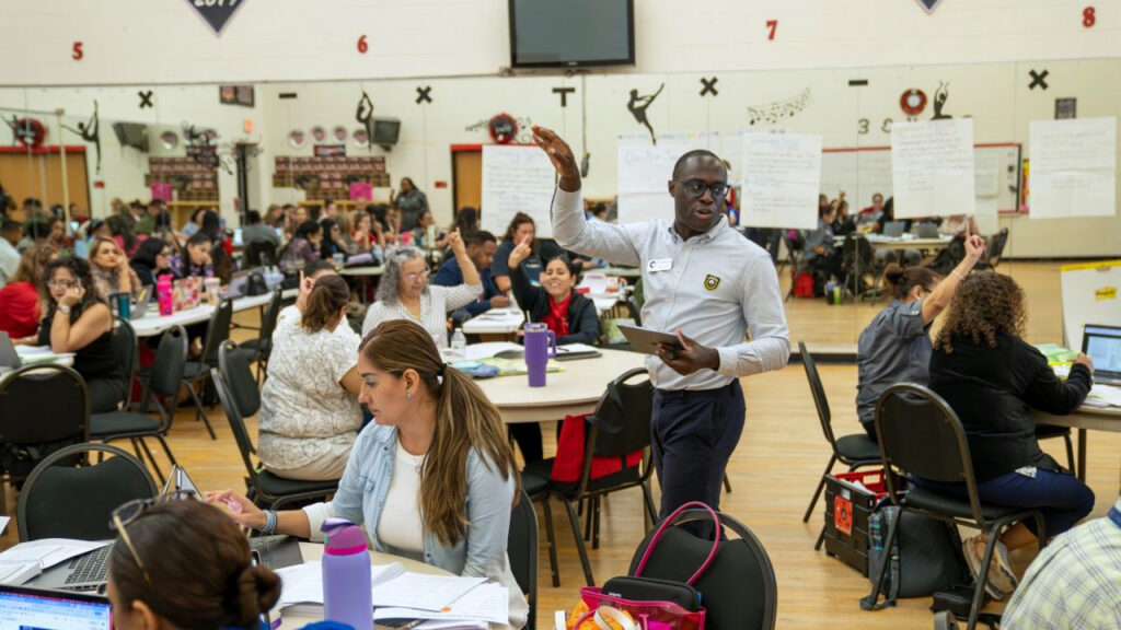 teachers work together in auditorium