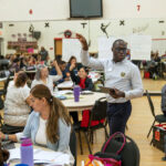 teachers work together in auditorium
