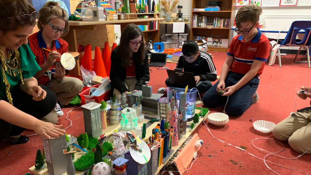 five students work on Future City project