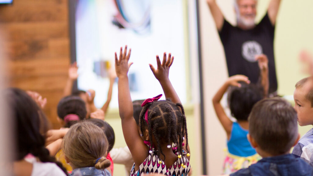 children raise their hands